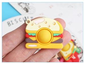 Close-up of burger-shaped silicone keychain fidget toy with realistic layered details
