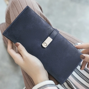 Long dark blue matte PU leather wallet with silver metal buckle held by model