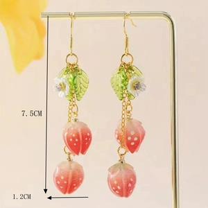 Macro detail of long strawberry pendant earrings with green leaves and dimensions