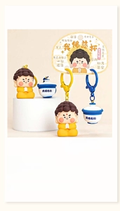 Close-up of cute monk figurine keychain set with bowl charm and blue carabiner