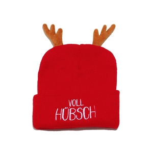 Detail of red Christmas knit hat with reindeer antlers and VOLL HÜBSCH embroidery text