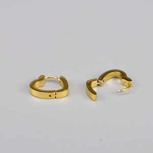 Detailed macro view of heart-shaped gold hoop earrings with functional hinge mechanism