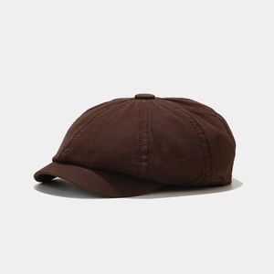 Close-up of deep coffee cotton newsboy cap with classic eight-panel stitching and top button