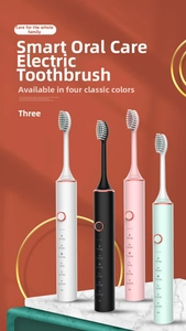 Vertical view of four electric toothbrushes in white, black, pink and green on marble