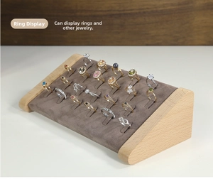 Detailed view of 20-slot wooden ring display stand with gray velvet slanted surface