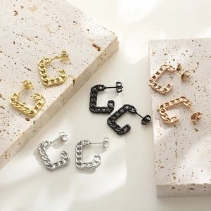 Detail view showing Cuban link C-shaped earrings in matte black, silver, gold and rose gold