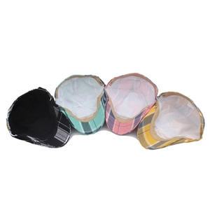 Detailed view of four colorful plaid flat caps with inner lining and care labels