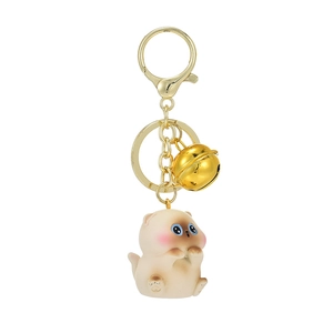 Cute Siamese kitten keychain with large blue eyes and a gold bell on a white background