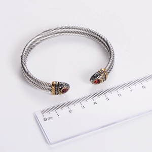 Stainless steel twisted cable bracelet with red gemstone and gold accents