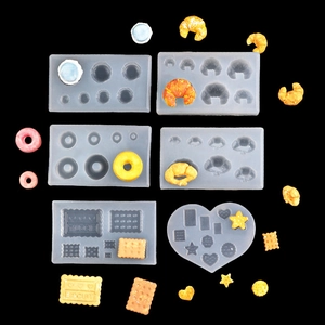 Detail of translucent silicone molds for making miniature croissants and donut food models