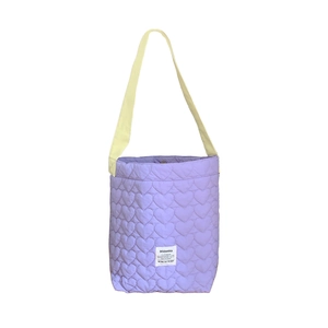 Purple quilted shoulder bag with heart pattern and yellow strap on white background