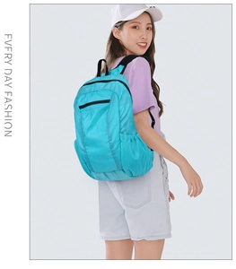 Lake blue foldable backpack in tear-resistant nylon shown from side profile on female model