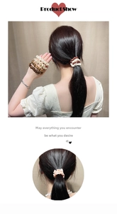 Detail of satin scrunchies in earth tones worn on ponytail and wrist for high elasticity