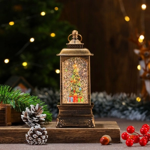 Macro detail of a vintage bronze Christmas water lantern with a rotating glitter Xmas tree