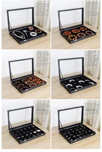 Detalle del joyero de cuero negro con tapa de vidrio y seis opciones de compartimentos