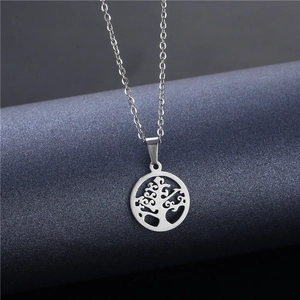 Silver tree of life pendant necklace in stainless steel on a dark display stand