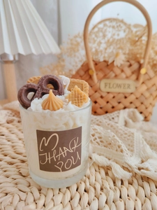 Detail of a strawberry chocolate dessert candle with waffle decor and Thank You sticker