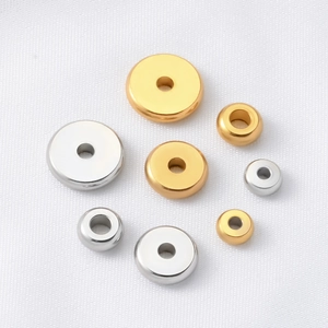 Detailed top view of gold and silver flat spacer beads in various sizes for DIY jewelry
