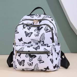 Lightweight white nylon backpack featuring black butterfly prints and gold zipper hardware