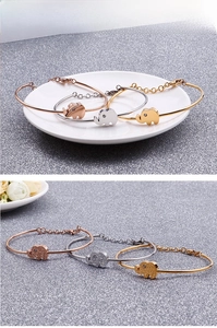 Detailed close-up of polished elephant charms with sparkling crystal on bangles set