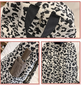 Detail of leopard print corduroy backpack featuring reinforced handle and side pockets