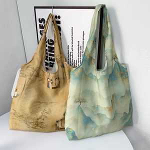 Detail of vintage canvas tote bags featuring traditional Chinese landscape art patterns