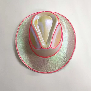 Detail view of pearlescent cowboy hat with pink LED EL wire glowing edges and holographic finish