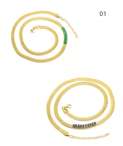 Detail of 18K gold plated snake chain with green and black zircon rectangular gemstones
