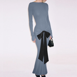 Detail of elegant Morandi blue long sleeve dress with a large black satin bow at the waist