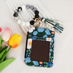 Floral card holder with silicone bead bracelet, zipper pocket, and decorative tassel detail