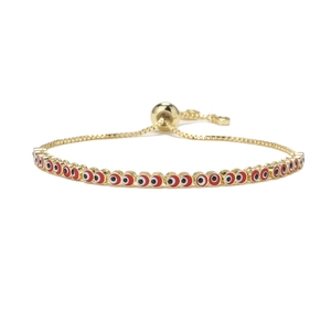 Adjustable gold box chain bracelet with red evil eye enamel charms on white background