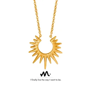Detailed view of a gold plated sunburst starburst pendant necklace with a fine chain link