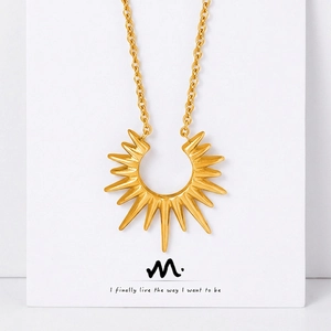 Minimalist gold-plated sunburst geometric pendant necklace with sharp rays on white background