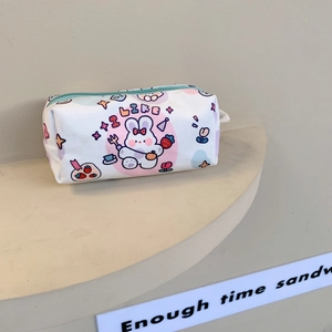 Close-up of white canvas pencil case with cute cartoon prints and light blue zipper