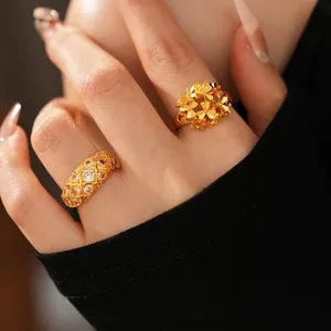 24k gold-plated floral and diamond-encrusted rings shown on model in close-up shot