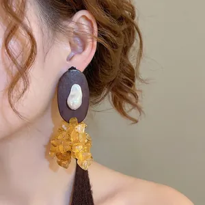 Ethnic resin wood drop earrings with oval beads and baroque pearl on model