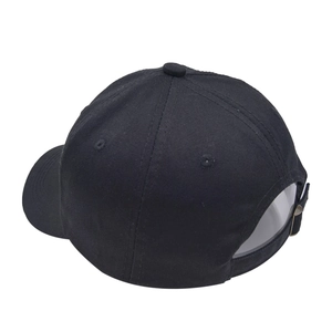 Detail view of the adjustable metal buckle and twill fabric on the black baseball cap