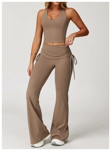 Detail of cross-waist flare yoga pants with adjustable ties in a coffee brown finish