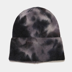 Close-up of black and grey tie-dye pattern on soft knitted winter beanie hat