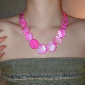 Close-up of vibrant pink shell bead necklace with a layered gradient design for summer