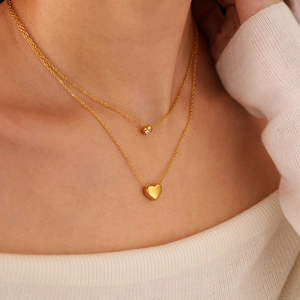 Close-up of double-layer gold heart necklace with sparkling rhinestone on model