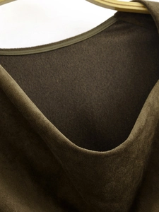Detailed macro view of high-quality dark brown faux suede fabric and neckline stitching