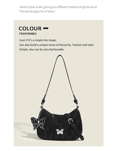 Macro detail of black pleated crescent bag featuring stylish silver butterfly pendants