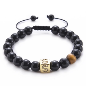 Detail of tiger eye bead and gold letter S charm on black onyx beaded bracelet