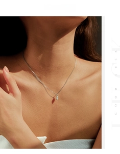 Detail of 925 silver necklace with marquise cut moissanite on model under warm sunlight