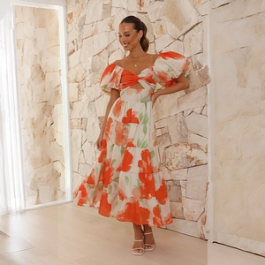 Detailed close-up of the deep V-neckline with twist knot and hollow waist floral design
