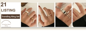Detail of gothic hand claw ring set featuring gold and silver chains and pearl accents