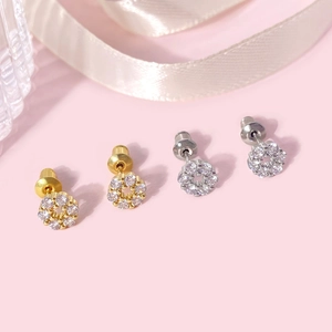 Macro view of small flower cluster stud earrings in 18k gold and silver with clear cubic zirconia