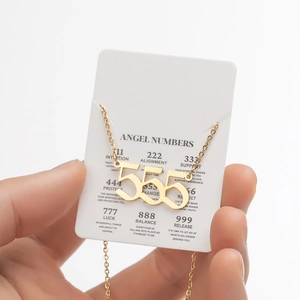 Detail of gold angel number 555 necklace with symbolic meaning card display