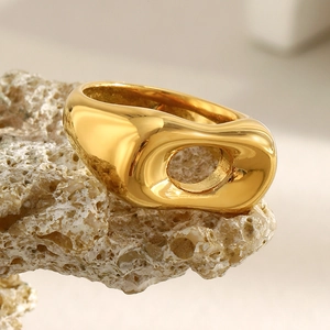 Minimalist 18K gold plated stainless steel hollow ring on natural stone background